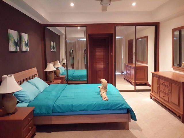 Condominium For Sale Jomtien showing the bedroom with door to the en-suite bathroom Condominium For Sale Jomtien showing the bedroom with door to the en-suite bathroom