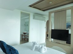 Condominium for sale Bangsaray Pattaya showing the sleeping area and bathroom 