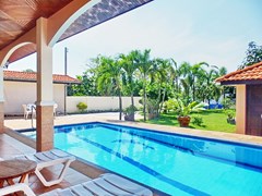 House for sale East Pattaya showing the covered terrace, pool and garden 