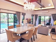 House for Sale Pattaya showing the dining and living areas with pool view 