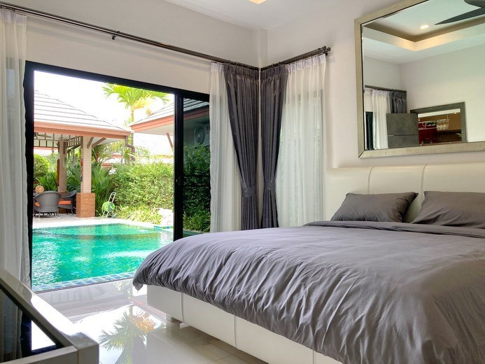 House for Sale Pattaya showing the master bedroom with pool view  