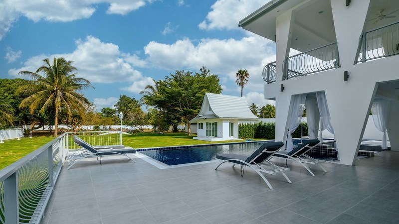 House for sale Pattaya showing the poolside terrace and pool House for sale Pattaya showing the poolside terrace and pool